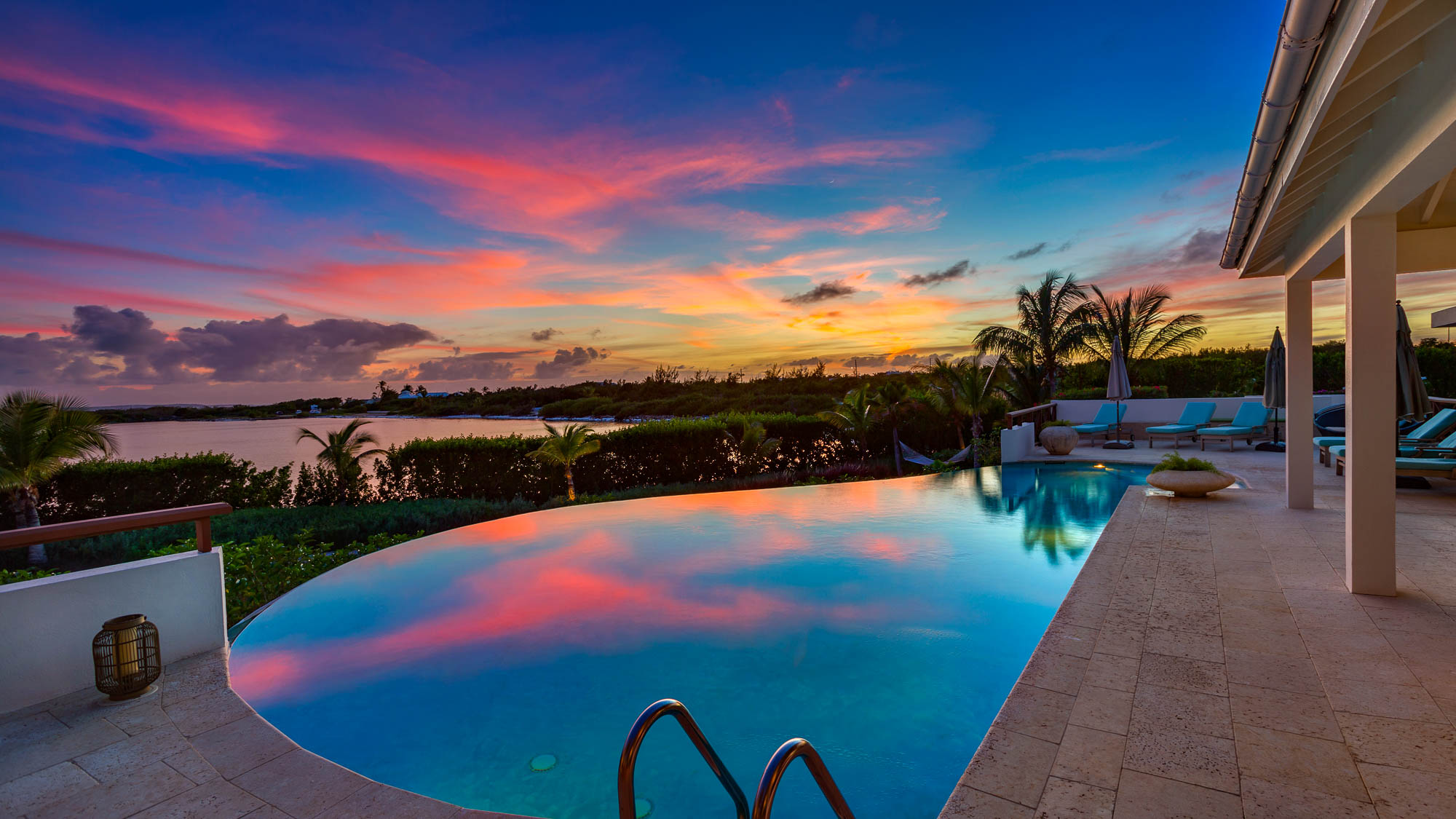 Seabird Villa glowing at dusk above the water
